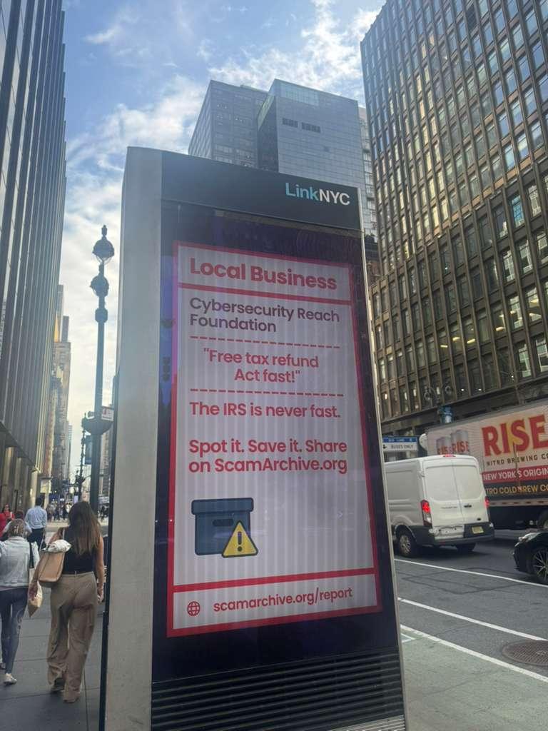 LinkNYC kiosk in Manhattan displaying the Cybersecurity Reach Foundation tax-scam awareness ad